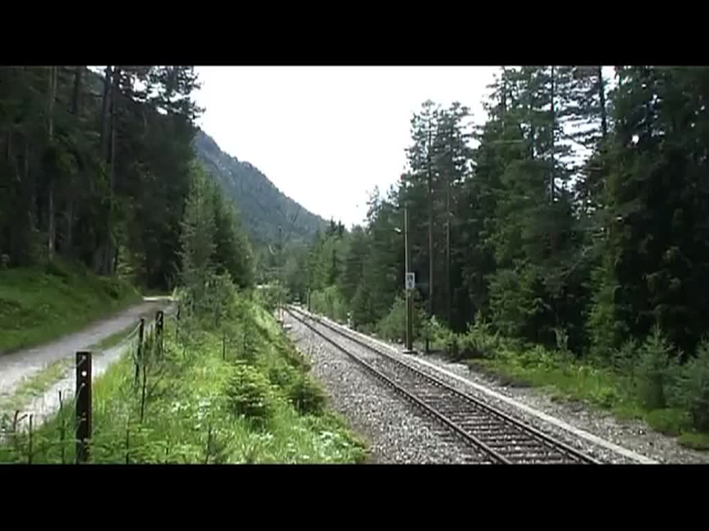 111 002 schiebt am 24.6.2011 einen RE bei Scharnitz nach München.