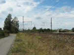 TX Logistik AG Auch einen sehr sch�nen Farbklecks im Alltags-Rot bietet die 185 518-8 der TXLogistik f�r transped. Hier bei Dedensen/G�mmer in Fahrtrichtung Seelze am 27.08.2009.
