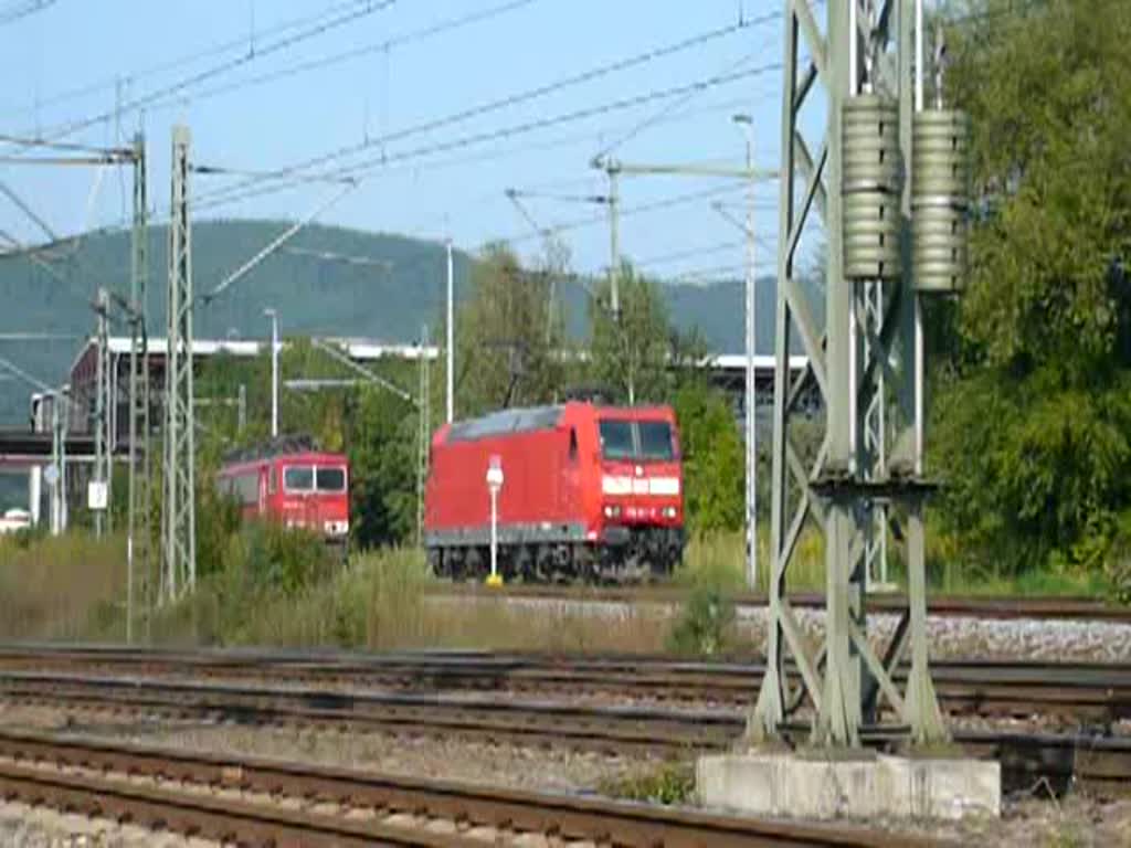 185 074-2 wird von einem Lokzug kurz hinter Saalfeld (Saale) abrangiert, passiert auffllig langsam die rtliche Brauerei ;-) und stoppt unter der Bahnhofsbrcke. (19.09.2009)