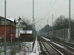 RE 18720 aus Dessau Richtung Berlin Wannsee fährt  am  16.02.2012 (?) gegen  14:20 Uhr in den Haltepunkt Beelitz Heilstätten ein, ein trüber, eher naßkalter Tag.